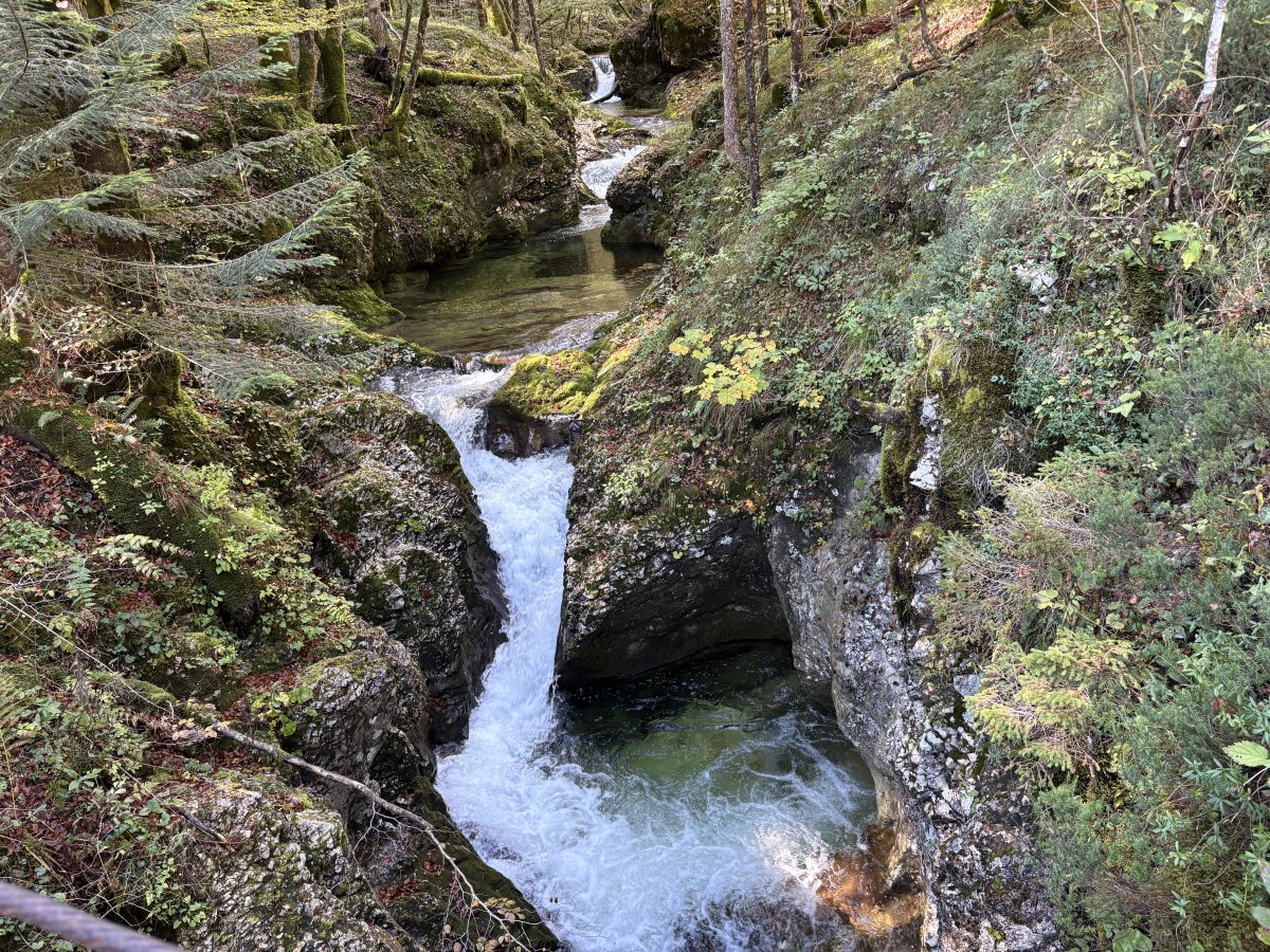 This is a stunning set of mini waterfalls along a side river flowing into the gorge, we are standing on a wooden bridge above the water..