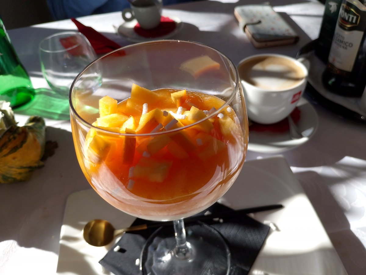 slices of local seasonal kaki fruit in panne cotta..