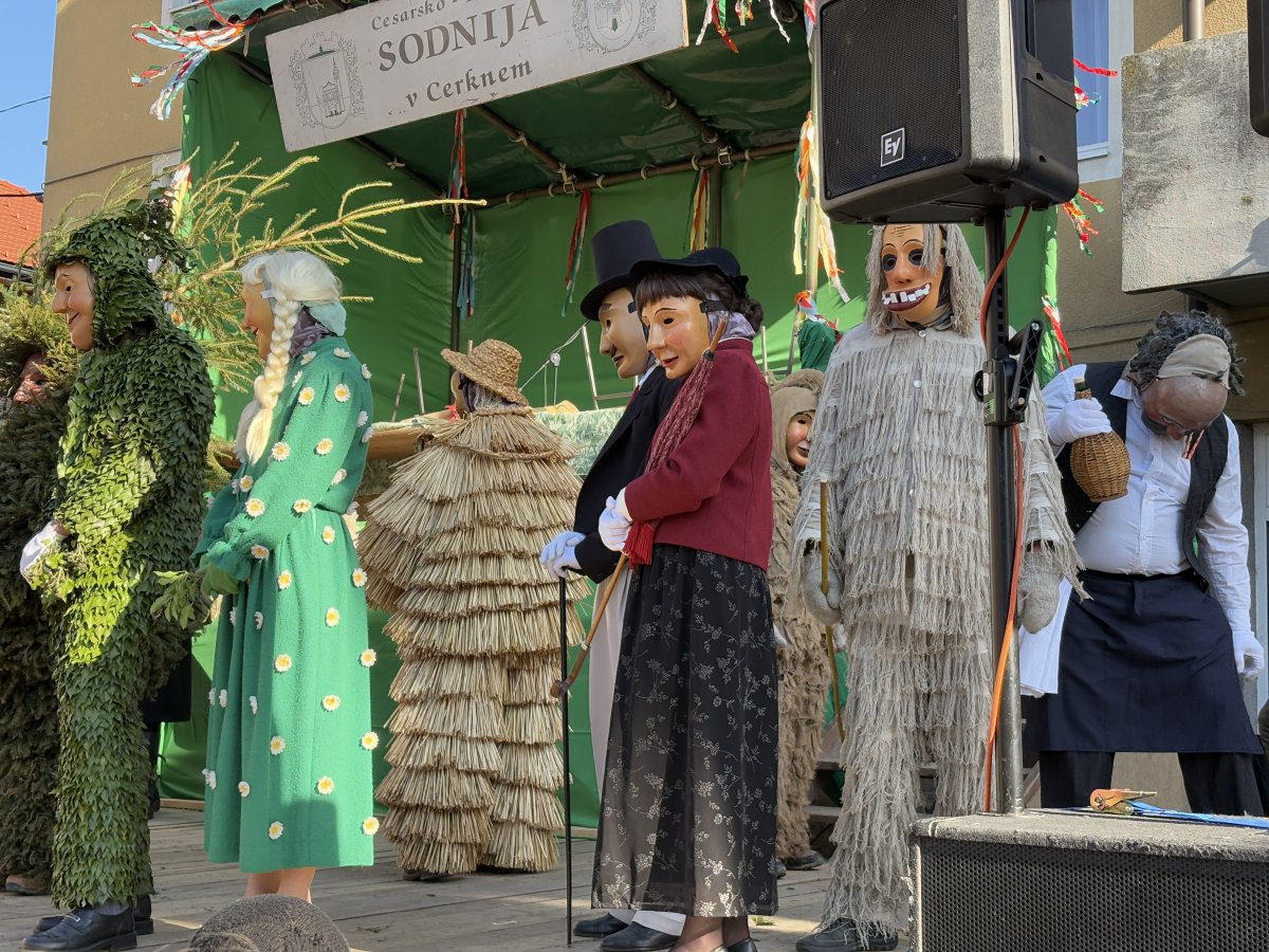 the characters wait patiently on the stage and wave at the crowd..