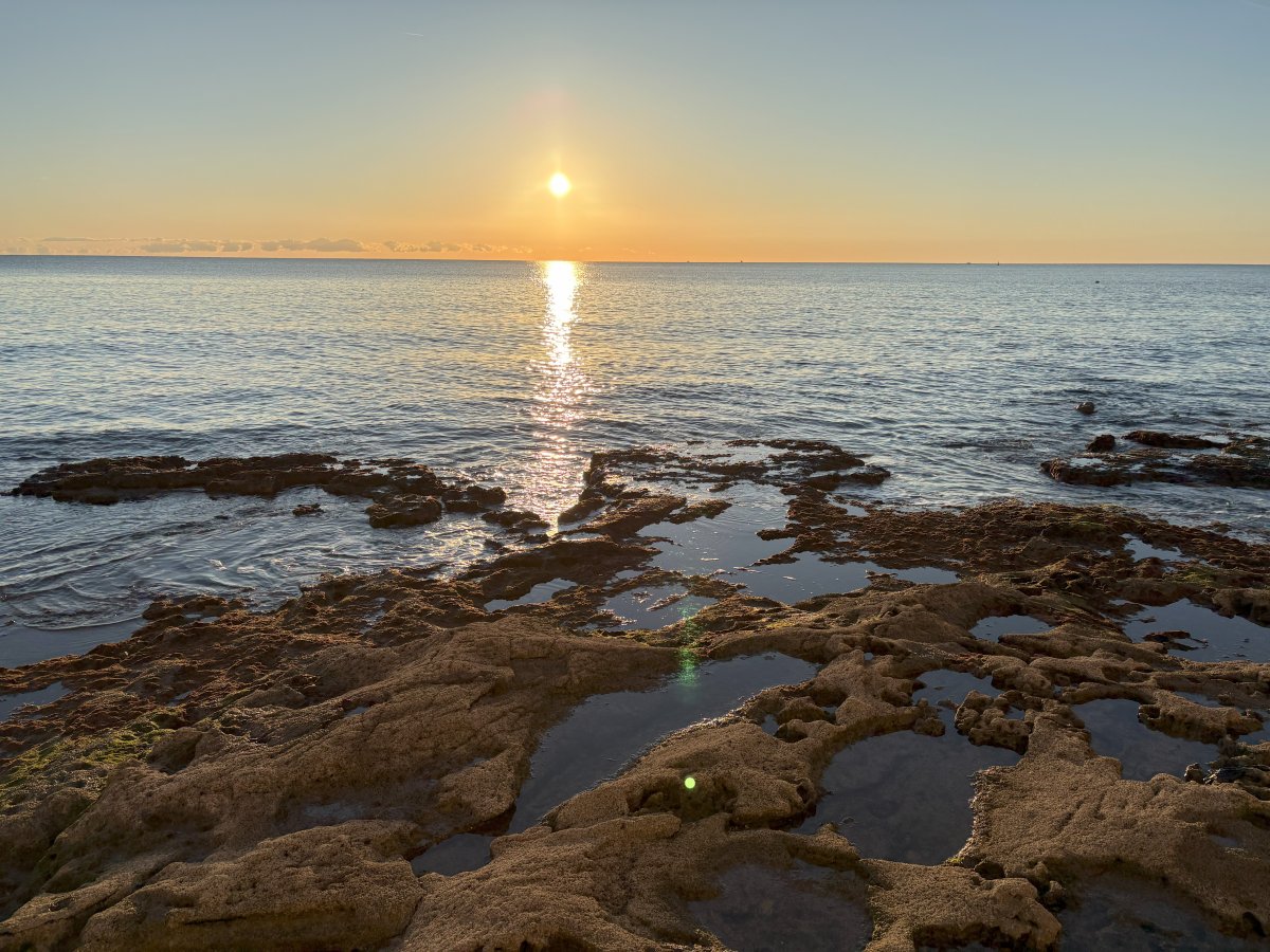 Typical Adriatic rock beach with lake like Medieterranean sea at Novigrad..