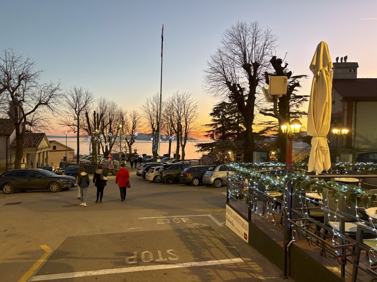 Chritmas lights go on at Kastav with Cres island down below in the bay..